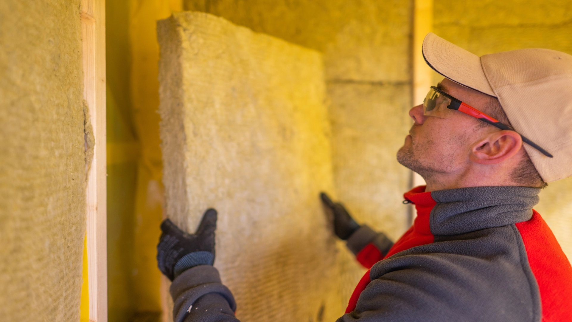 A man doing insulation in basement to make it Energy-Efficient Space