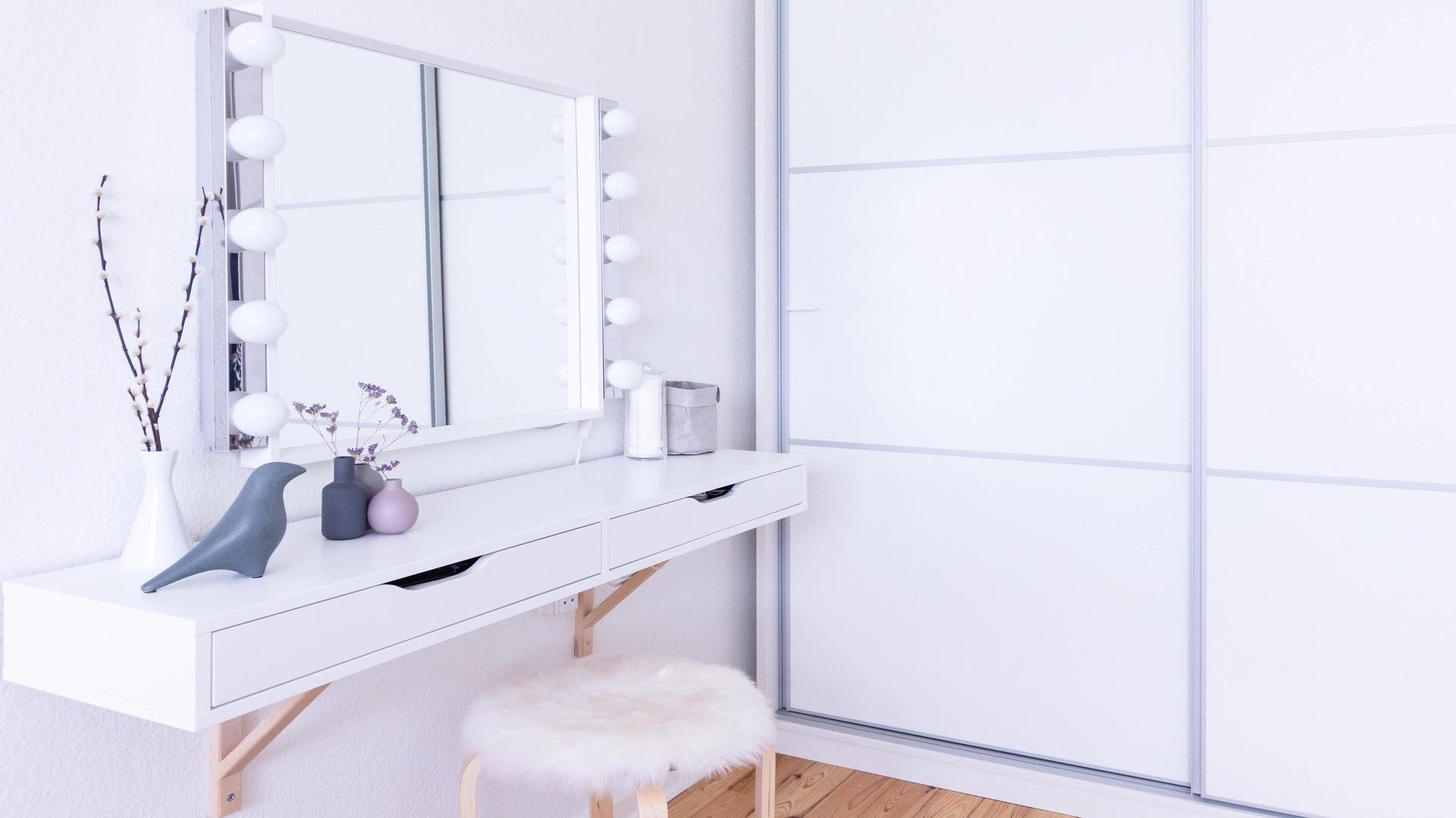 A mirror with lights on the dressing table  to brighten up the dark basement
