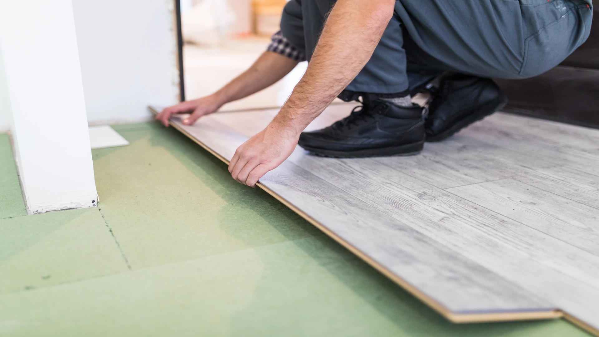 Man installing floor like rubber flooring for basement